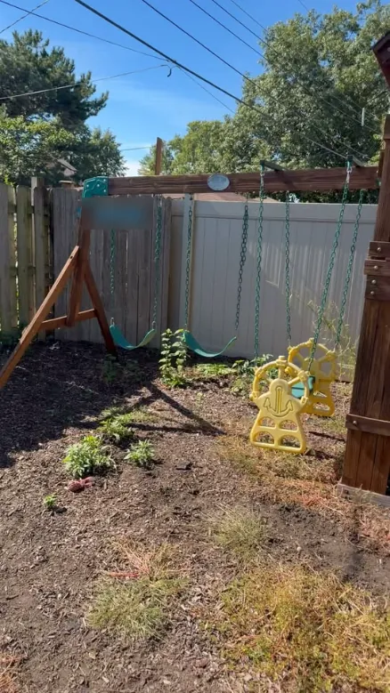 Wooden swing set in a backyard